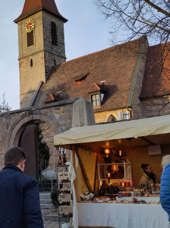 Kirche St. Katharina im Abendlicht, davor ein Marktstand